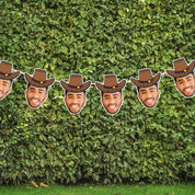 Mannequin heads with cowboy hats arranged against a green hedge.