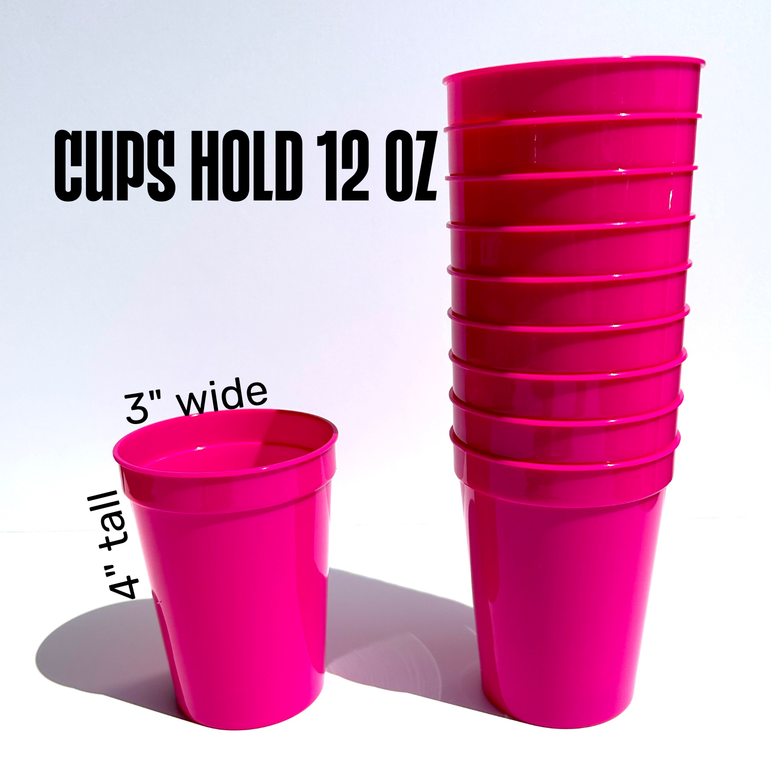 Stack of 12 oz pink plastic cups with measurements on a white background