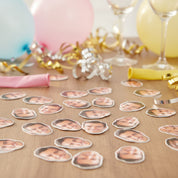 Stickers with faces on a table with party decorations in the background