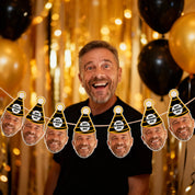 Man with a garland of smiling faces against a festive background with balloons and gold curtains.