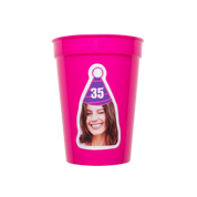 Pink plastic cup with a printed design of a woman wearing a party hat on a white background
