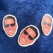 Three cut-out face masks of a man wearing sunglasses on a blue textured background