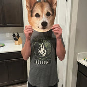 Person holding a cardboard cut out with a dog's face printed on it in a kitchen.