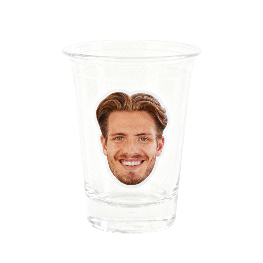 Clear glass with a printed face on a white background