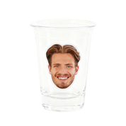 Clear glass with a printed face on a white background